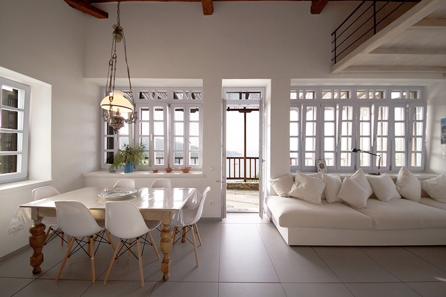 living and dining area with balcony and sea beyond